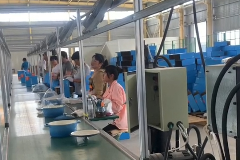 Workers are packing the finished blue enameled cast iron casserole