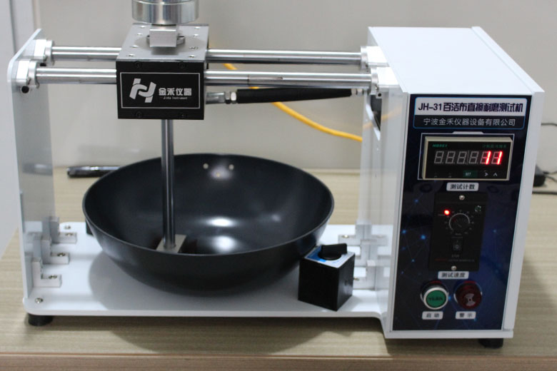 Lightweight cast iron wok undergoing wear test